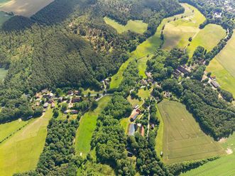 Luftbildaufnahme von Borstel 2024, zeigt eine grüne Landschaft mit Wäldern, Feldern und verstreuten Wohngebäuden.
